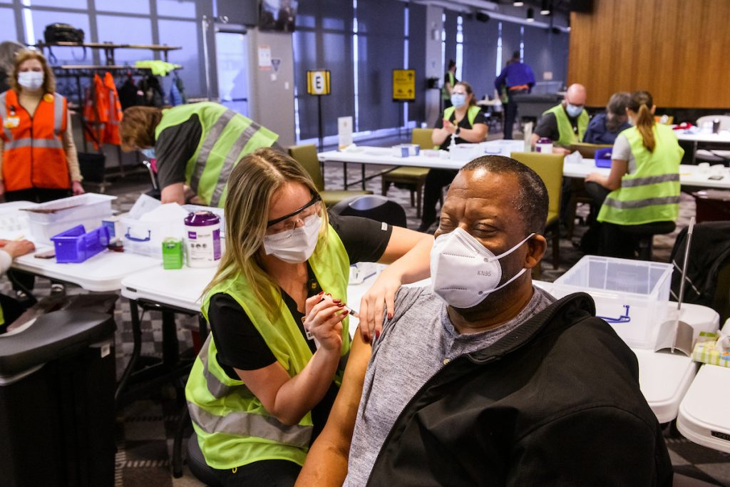 University of Missouri Sinclair School of Nursing student Hannah Tipton administers a COVID-19 vaccine to Clifford Nevins during MU Health Care’s vaccination clinic in the Walsworth Family Columns Club